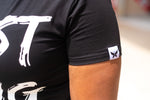 Black Beast Gang crop top with white lettering worn by Jamie Frances. Top has butterfly logo stitched on left sleeve.